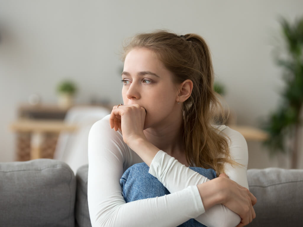 upset woman sitting on a couch