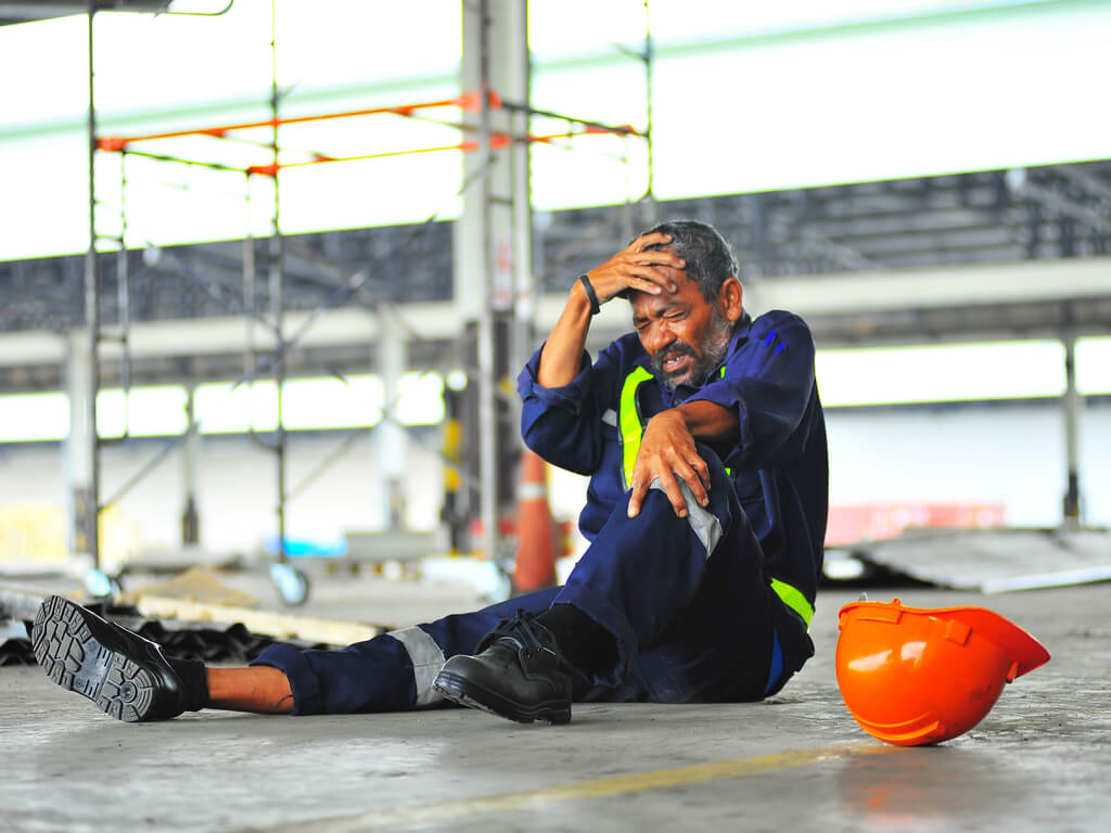 worker holding his head after a fall